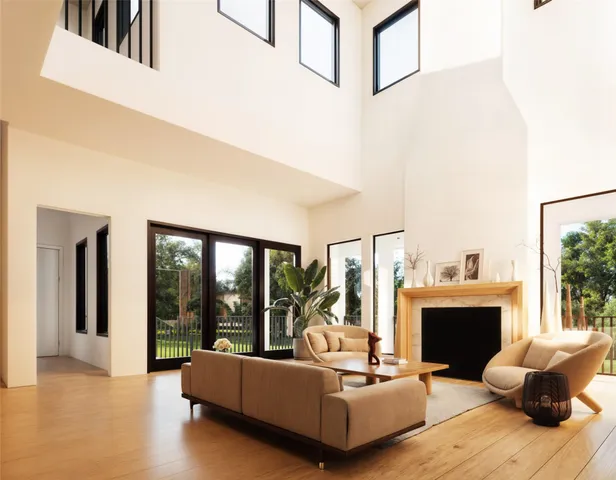 a living room with furniture a large window and a fireplace
