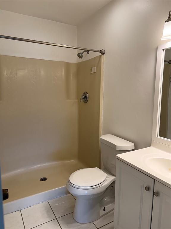 6040 Shaker Wood Circle, Unit 205 Tamarac, FL 33319 - Photo 13 of 14 a bathroom with a toilet a sink and shower