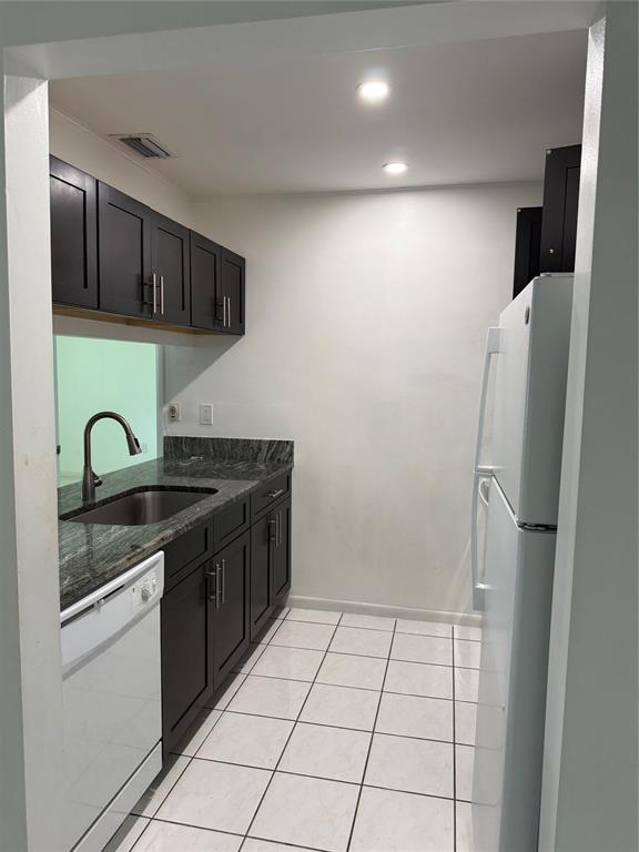 6040 Shaker Wood Circle, Unit 205 Tamarac, FL 33319 - Photo 3 of 14 a kitchen with stainless steel appliances granite countertop a refrigerator and a sink