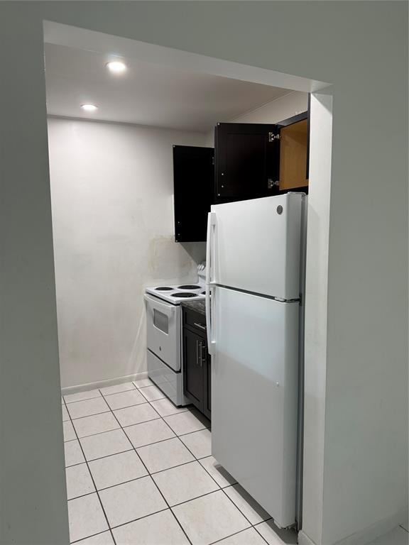 6040 Shaker Wood Circle, Unit 205 Tamarac, FL 33319 - Photo 5 of 14 a white refrigerator freezer and a stove sitting inside of a kitchen