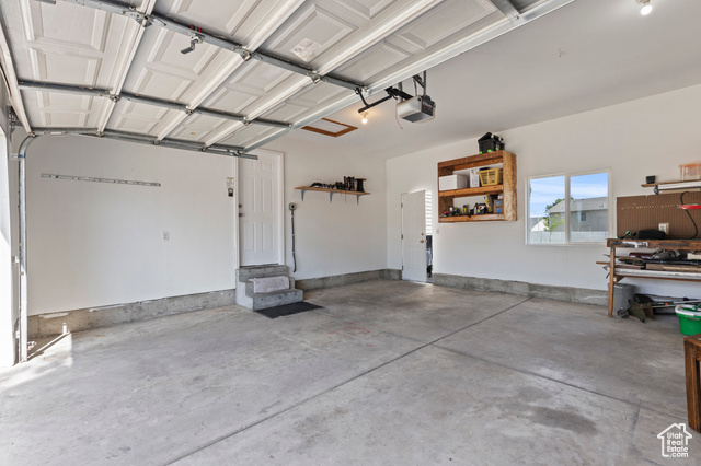 1099 Three Point Avenue Logan, UT 84321 - Photo 23 of 27 Garage featuring a garage door opener