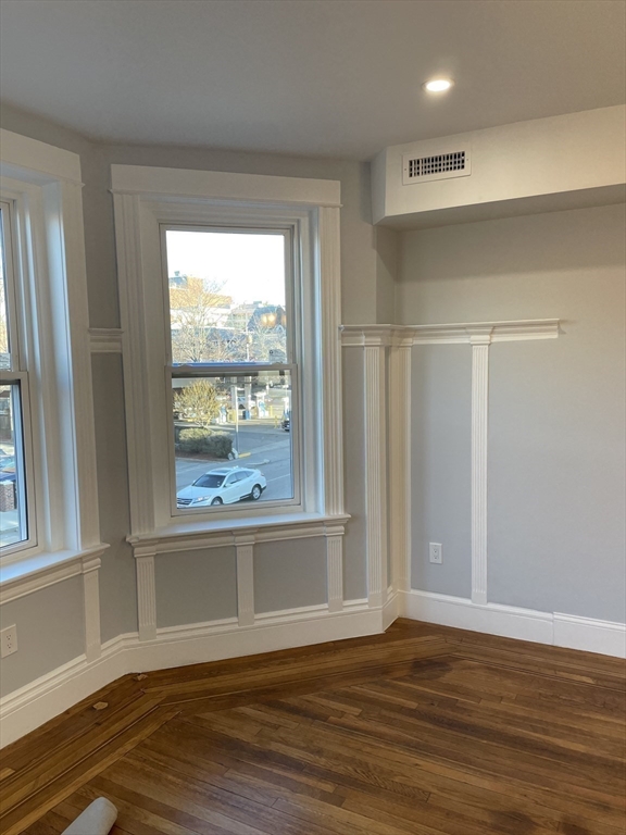 3 Alton Place, Unit 2 Brookline, MA 02446 - Photo 14 of 42 a view of an empty room with wooden floor and a window