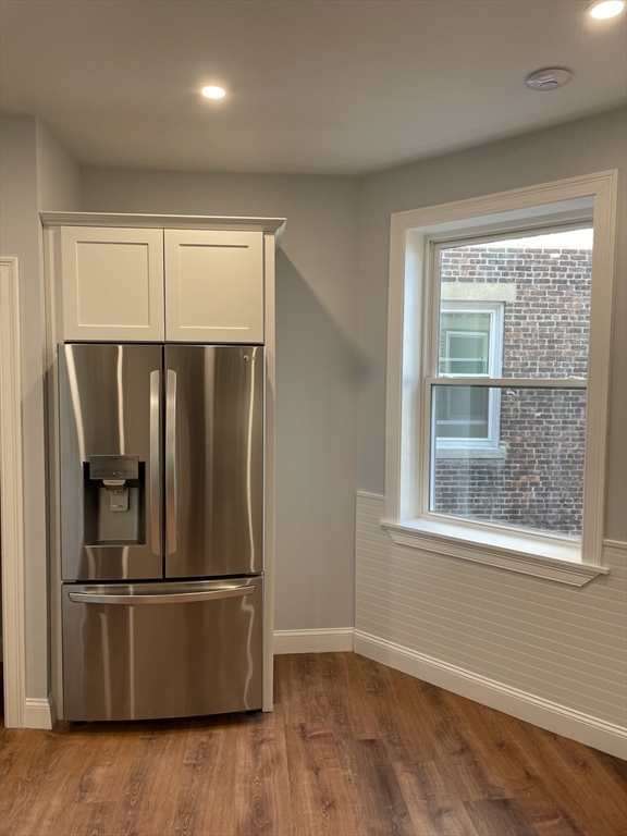 3 Alton Place, Unit 2 Brookline, MA 02446 - Photo 17 of 42 an empty room with wooden floor and window