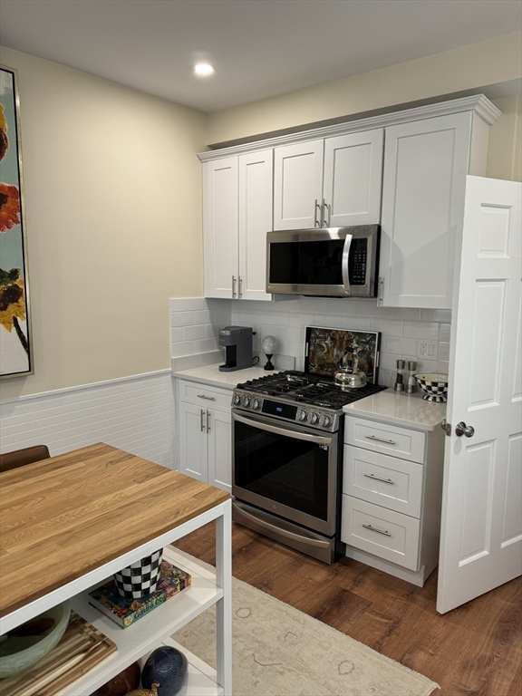 3 Alton Place, Unit 2 Brookline, MA 02446 - Photo 18 of 42 a kitchen with stainless steel appliances white cabinets and stove top oven