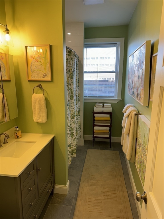 3 Alton Place, Unit 2 Brookline, MA 02446 - Photo 24 of 42 a bathroom with a sink and a mirror