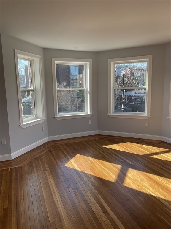 3 Alton Place, Unit 2 Brookline, MA 02446 - Photo 3 of 42 a view of empty room with wooden floor and fan