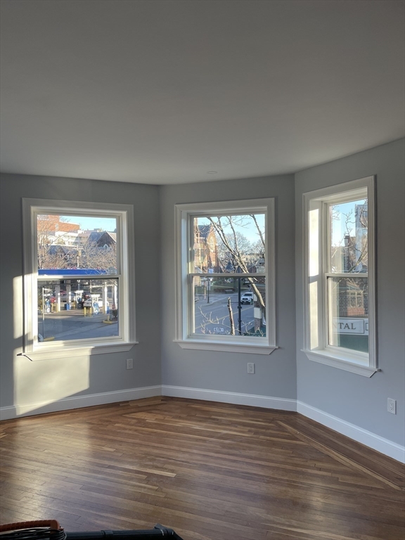3 Alton Place, Unit 2 Brookline, MA 02446 - Photo 4 of 42 a view of an empty room with wooden floor and a window