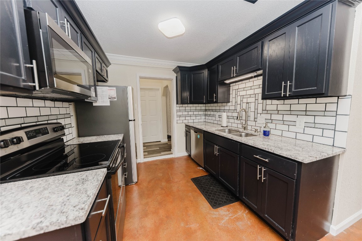 107 Silver Fox Waco, TX 76705 - Photo 12 of 33 a kitchen with stainless steel appliances kitchen island granite countertop a sink stove and cabinets