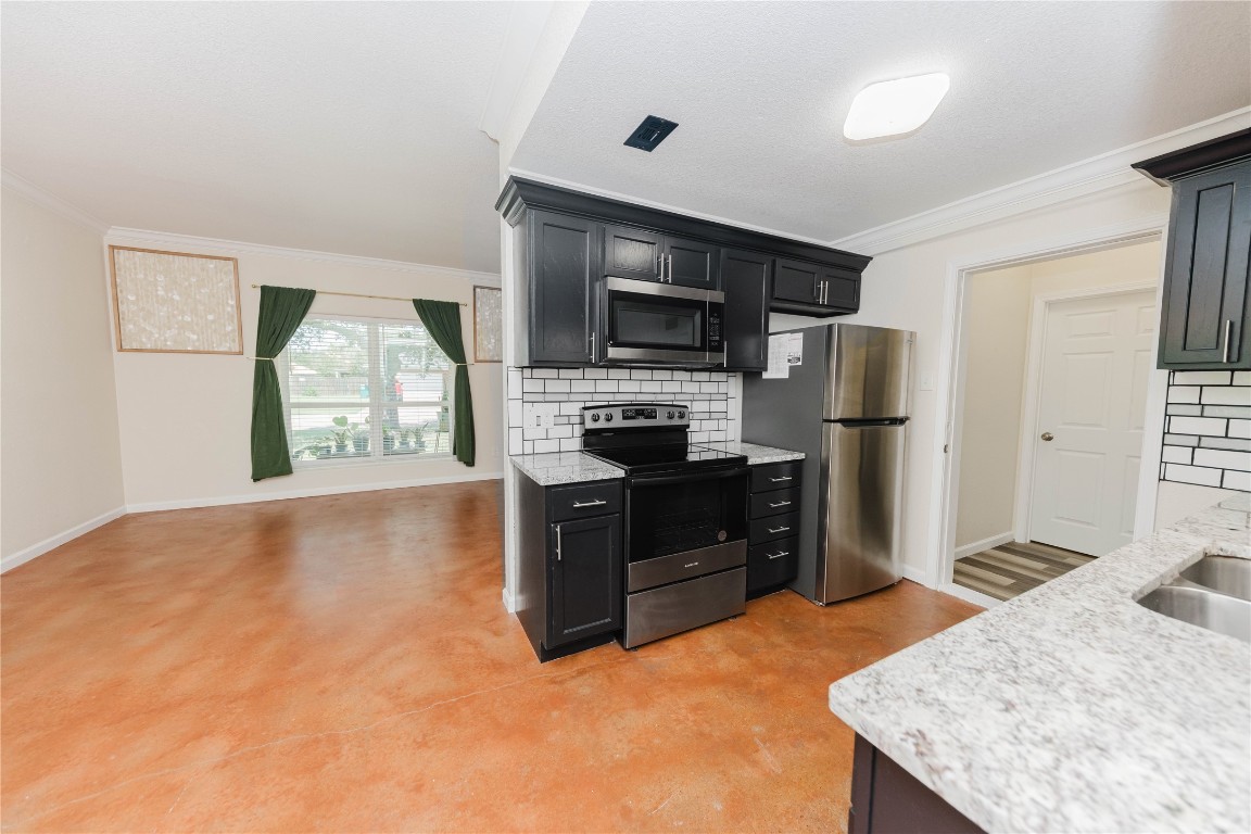 107 Silver Fox Waco, TX 76705 - Photo 13 of 33 a kitchen with stainless steel appliances granite countertop a refrigerator stove top oven and sink