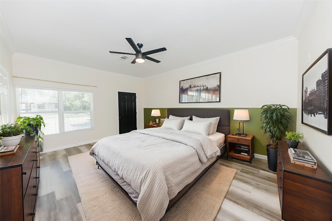 107 Silver Fox Waco, TX 76705 - Photo 18 of 33 a bedroom with a large bed and a chandelier