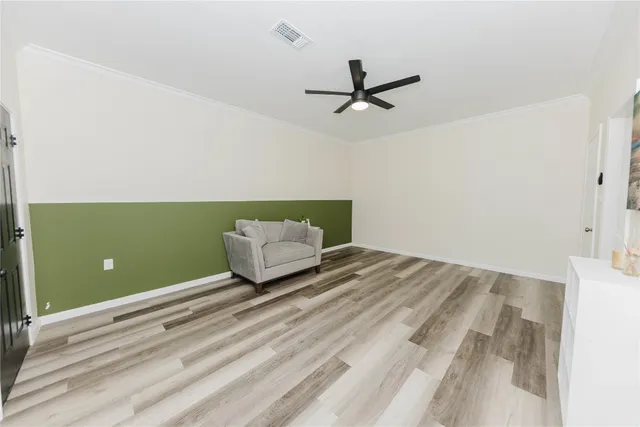 a view of a hallway with wooden floor and a bathroom