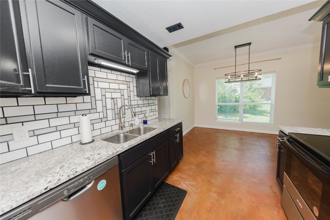 107 Silver Fox Waco, TX 76705 - Photo 21 of 33 a kitchen with granite countertop a sink stainless steel appliances and cabinets