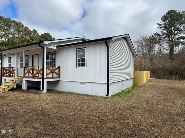 a backyard of a house with table and chairs