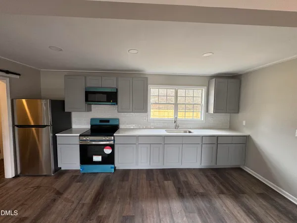 a kitchen with stainless steel appliances a refrigerator and a sink
