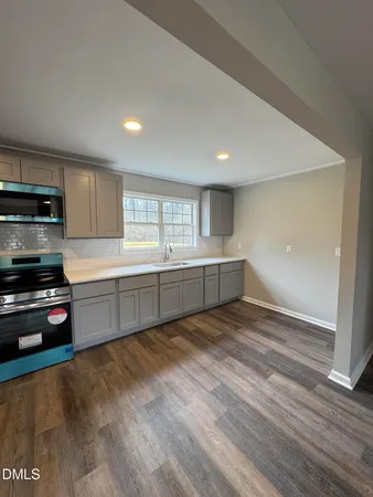 a view of a kitchen with a sink and cabinets