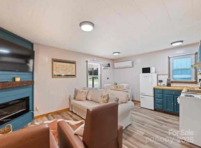 a living room with furniture a flat screen tv and a fireplace