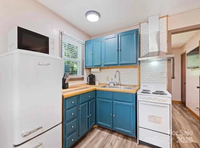 a kitchen with a sink window and cabinets