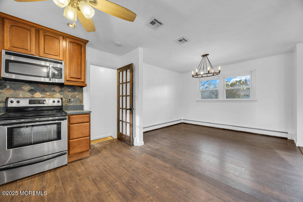 Undisclosed Address New Egypt, NJ 08533 - Photo 11 of 28 a kitchen with stainless steel appliances granite countertop a stove a microwave and a refrigerator