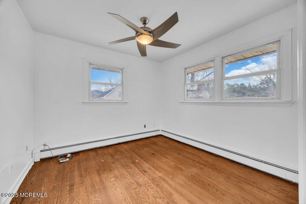 Undisclosed Address New Egypt, NJ 08533 - Photo 15 of 28 a view of an empty room with wooden floor and a ceiling fan