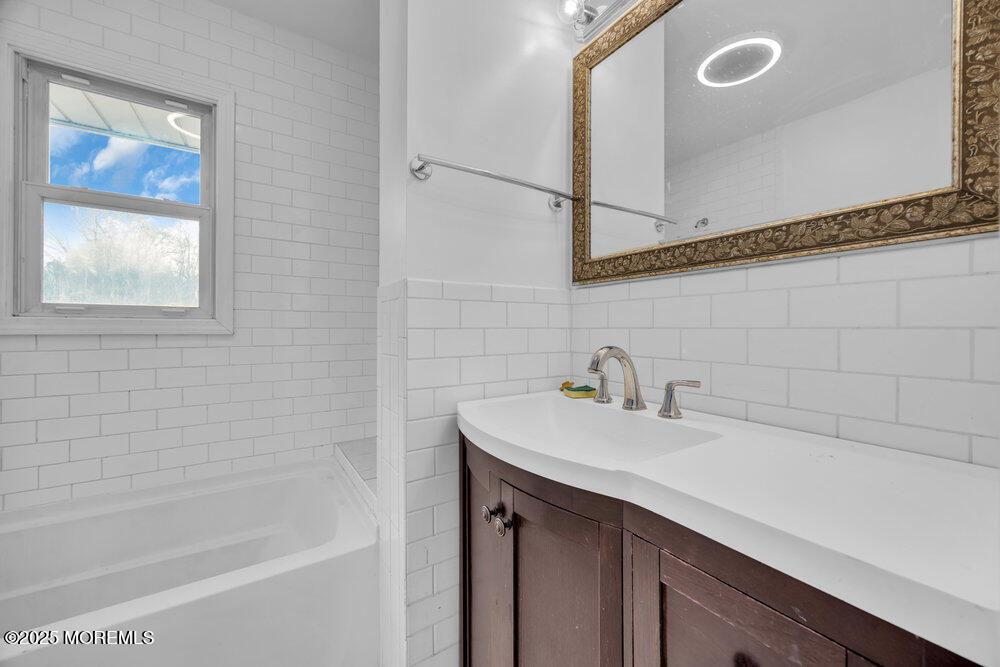 Undisclosed Address New Egypt, NJ 08533 - Photo 16 of 28 a bathroom with a sink a mirror and a bathtub