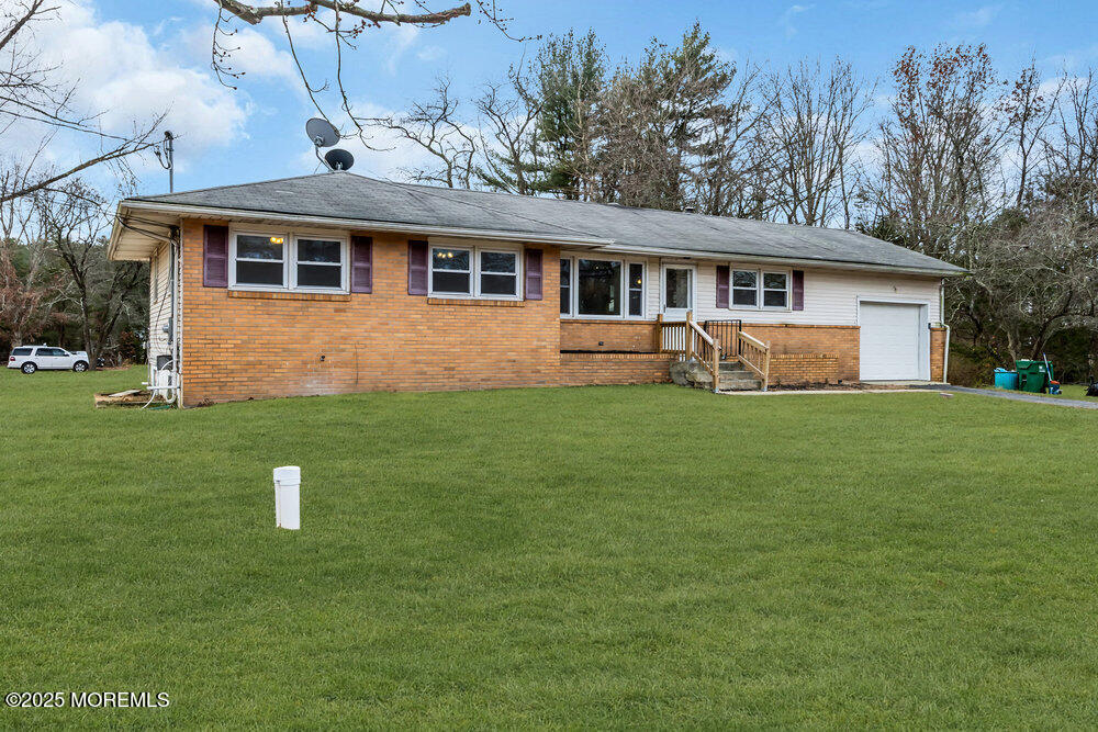Undisclosed Address New Egypt, NJ 08533 - Photo 2 of 28 a front view of a house with a yard and trees