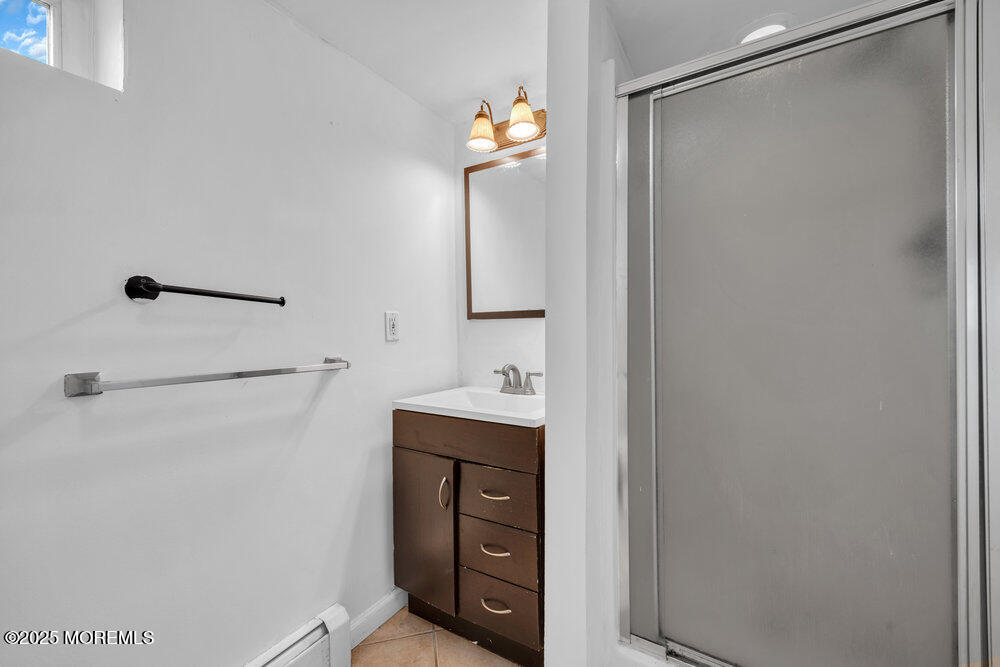 Undisclosed Address New Egypt, NJ 08533 - Photo 24 of 28 a bathroom with a light fixture a mirror and a shower