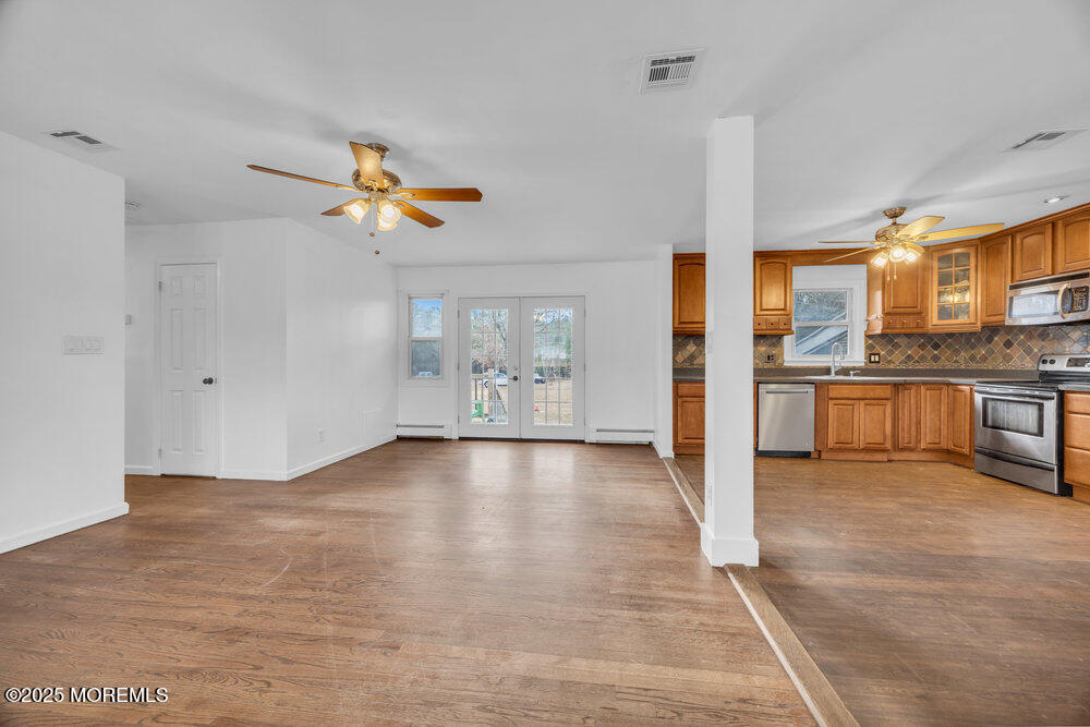 Undisclosed Address New Egypt, NJ 08533 - Photo 9 of 28 a view of a kitchen with a stove cabinets a ceiling fan and wooden floor