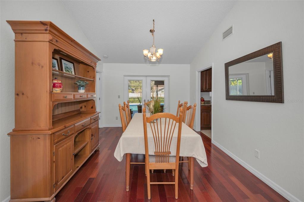 2949 Glenpark Road Palm Harbor, FL 34683 - Photo 14 of 60 a view of a dining room with furniture wooden floor and chandelier