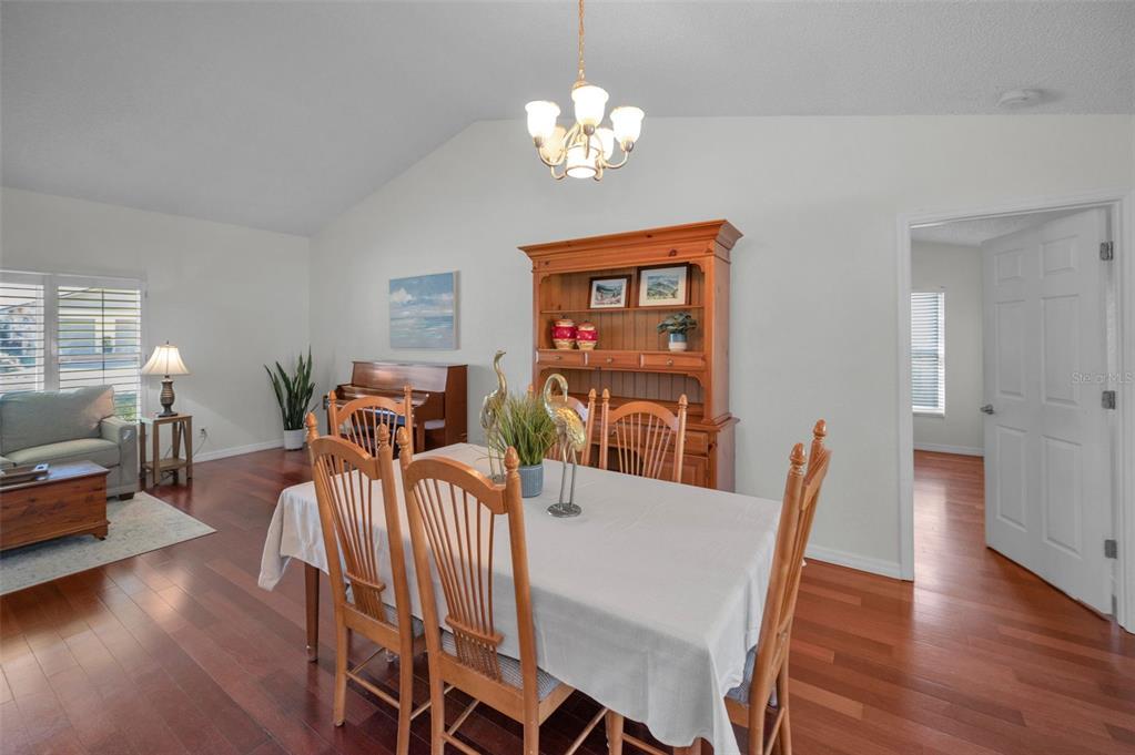 2949 Glenpark Road Palm Harbor, FL 34683 - Photo 15 of 60 a view of a dining room with furniture wooden floor and chandelier