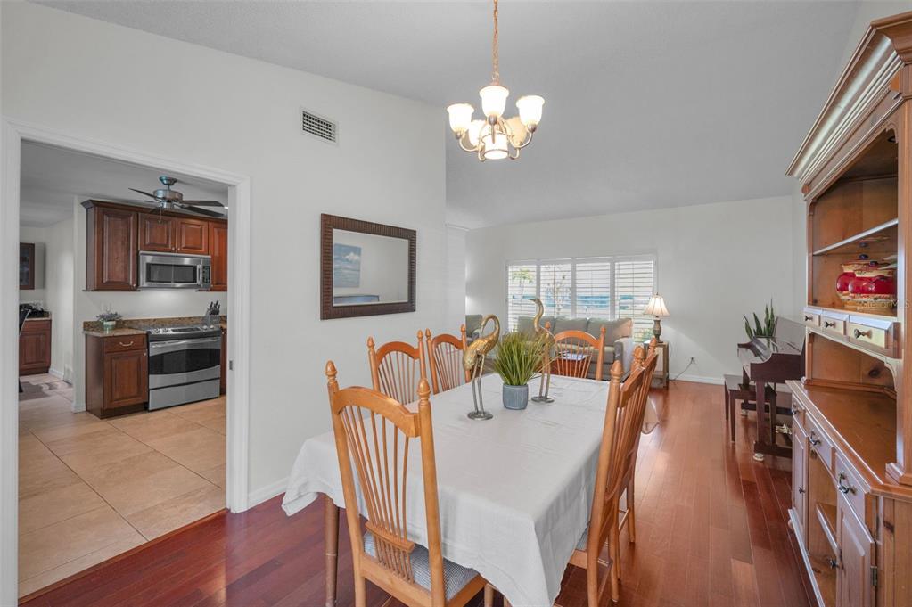 2949 Glenpark Road Palm Harbor, FL 34683 - Photo 16 of 60 a view of a dining room with furniture a chandelier and wooden floor