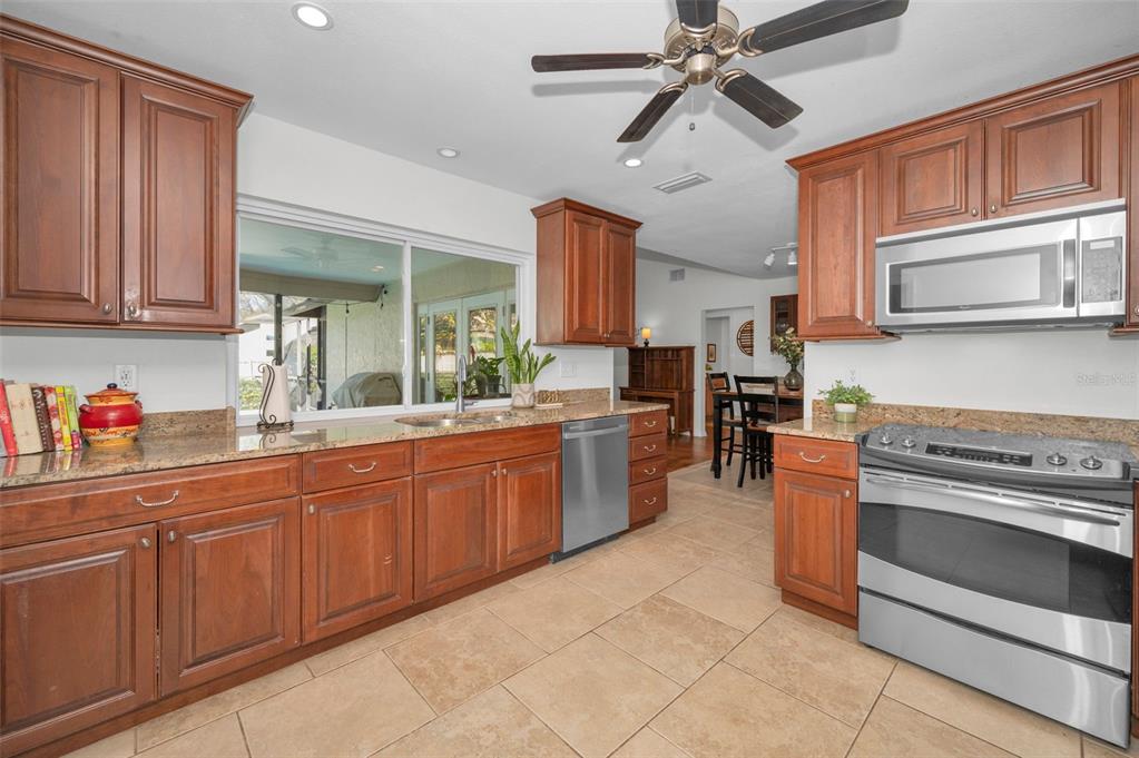 2949 Glenpark Road Palm Harbor, FL 34683 - Photo 18 of 60 a kitchen with stainless steel appliances granite countertop a stove and a sink