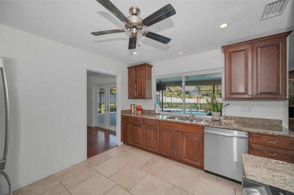 2949 Glenpark Road Palm Harbor, FL 34683 - Photo 19 of 60 a kitchen with granite countertop stainless steel appliances a sink and cabinets