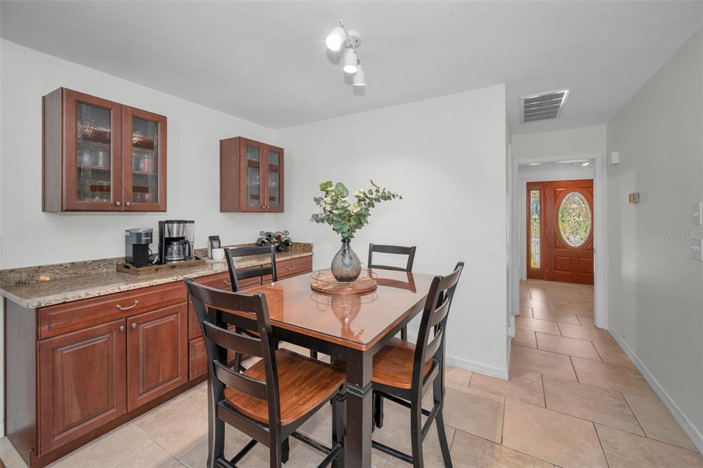 2949 Glenpark Road Palm Harbor, FL 34683 - Photo 22 of 60 a dining room with a wooden table and chairs
