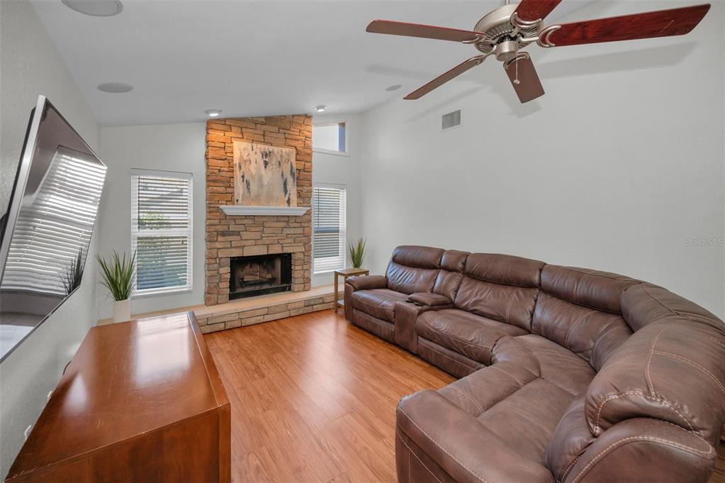 2949 Glenpark Road Palm Harbor, FL 34683 - Photo 27 of 60 a living room with furniture and a fireplace