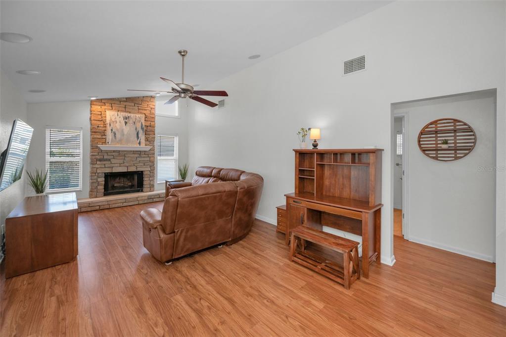 2949 Glenpark Road Palm Harbor, FL 34683 - Photo 28 of 60 a living room with furniture and a fireplace
