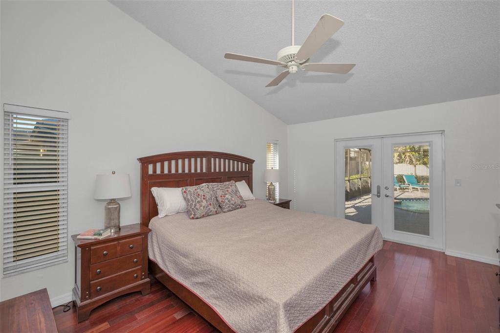 2949 Glenpark Road Palm Harbor, FL 34683 - Photo 32 of 60 a bedroom with a large bed and a chandelier