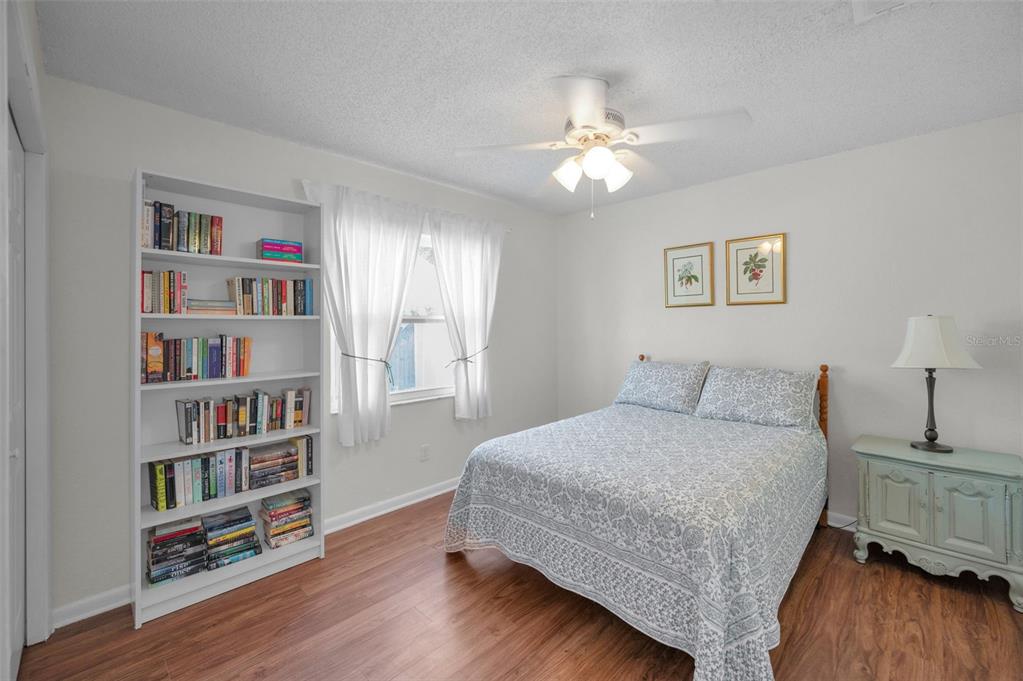 2949 Glenpark Road Palm Harbor, FL 34683 - Photo 36 of 60 a bedroom with a bed a book shelf and a window