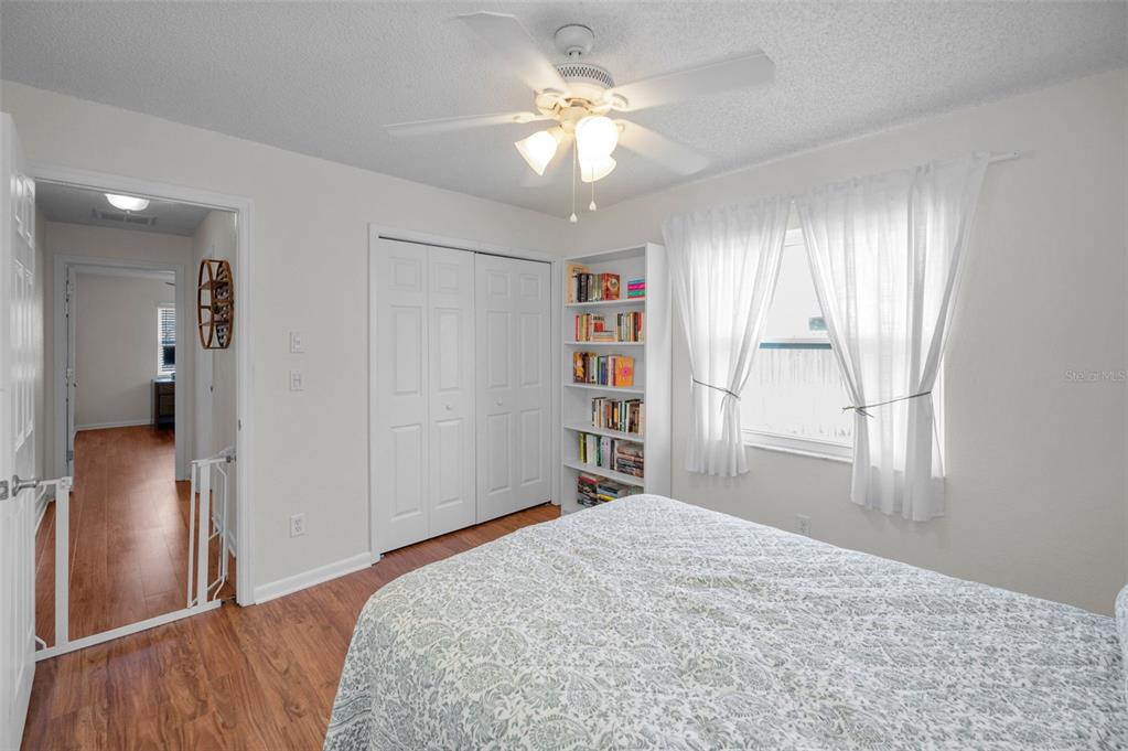 2949 Glenpark Road Palm Harbor, FL 34683 - Photo 37 of 60 a bedroom with a bed and a chandelier