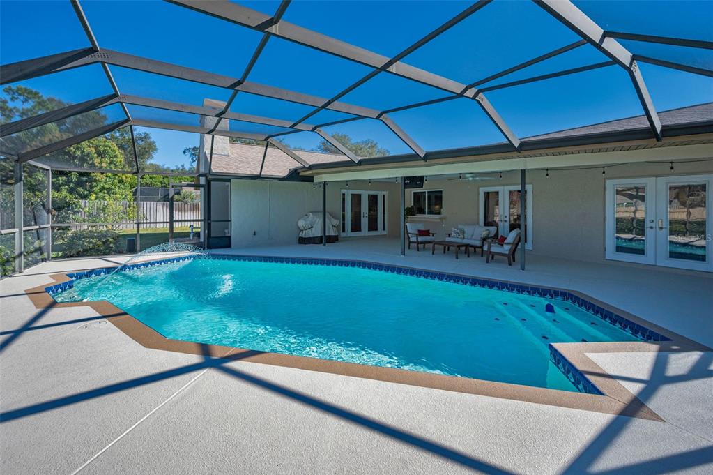2949 Glenpark Road Palm Harbor, FL 34683 - Photo 52 of 60 a view of a backyard with table and chairs under an umbrella
