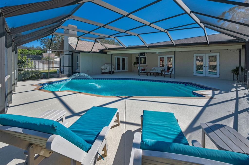 2949 Glenpark Road Palm Harbor, FL 34683 - Photo 53 of 60 a view of a patio with table and chairs under an umbrella