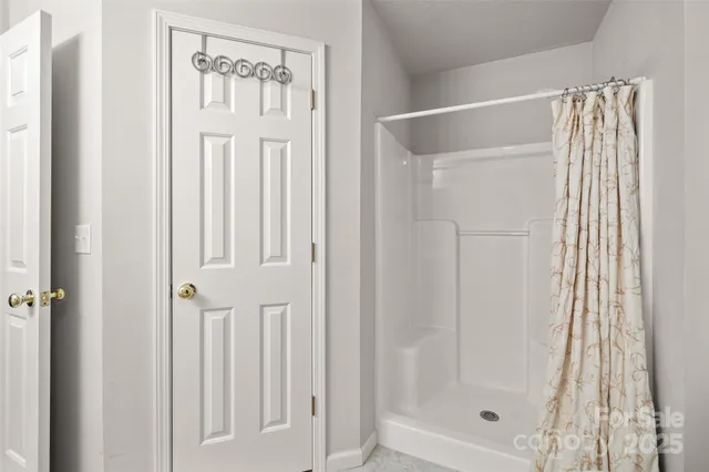a bathroom with a glass shower door