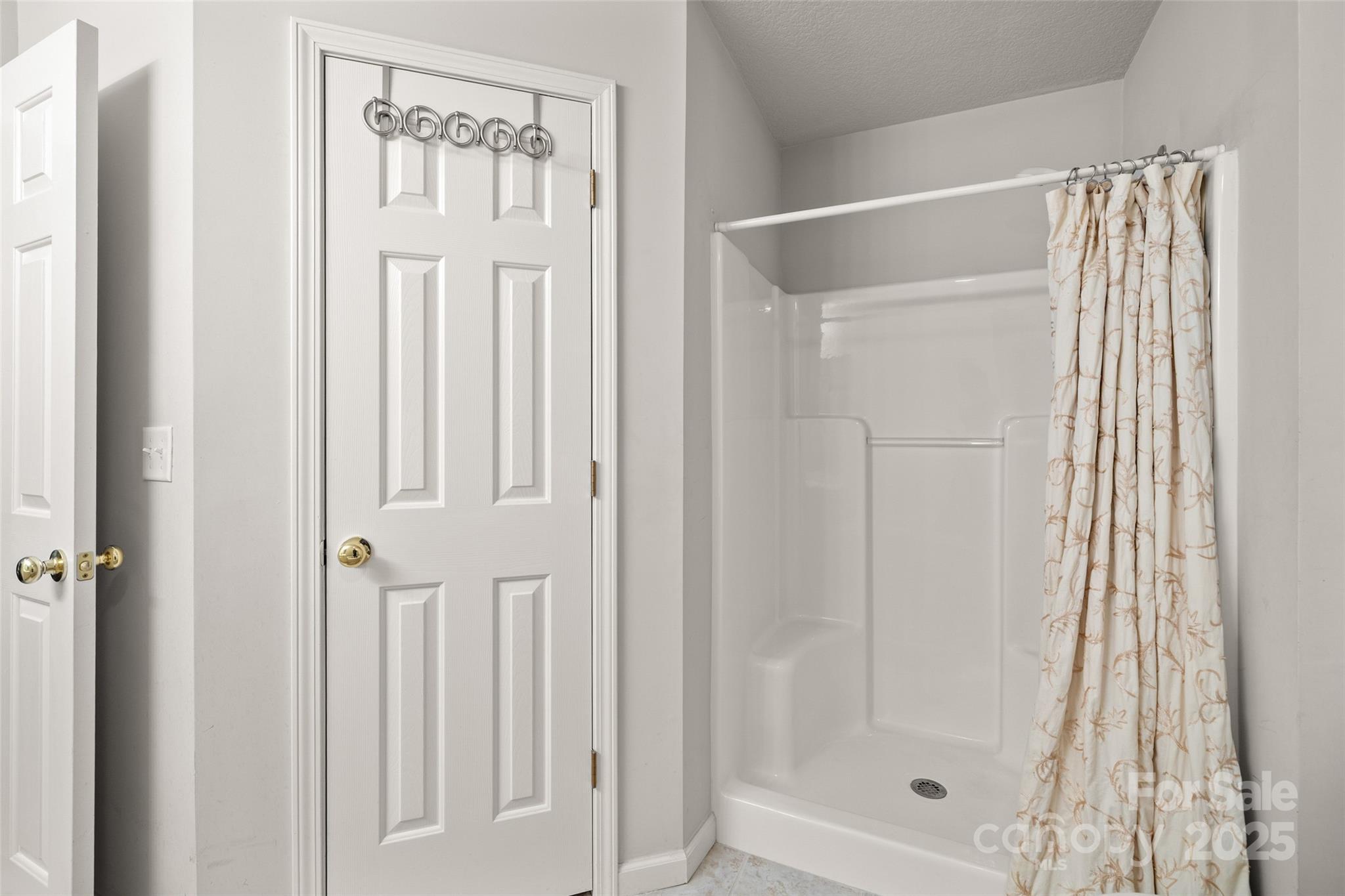 270 Farington Circle Fletcher, NC 28732 - Photo 12 of 29 a bathroom with a glass shower door