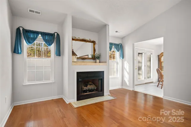a view of an empty room with window and fire place