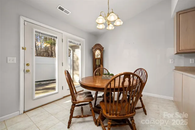 a view of a dining room with furniture and chandelier