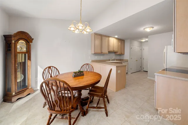 a dining room with furniture and chandelier