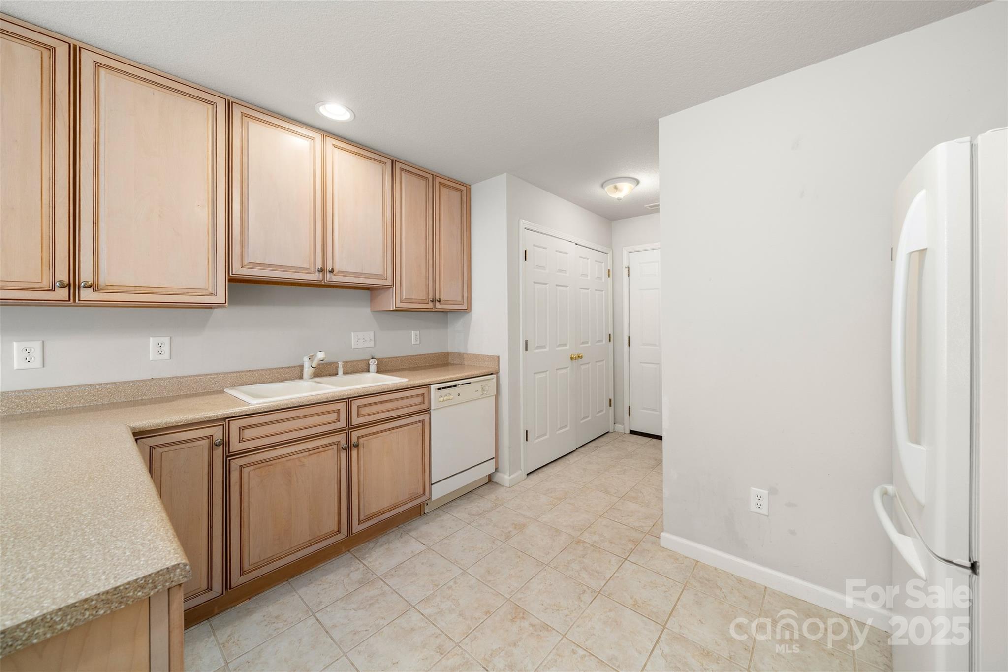 270 Farington Circle Fletcher, NC 28732 - Photo 24 of 29 a kitchen with white cabinets and white appliances