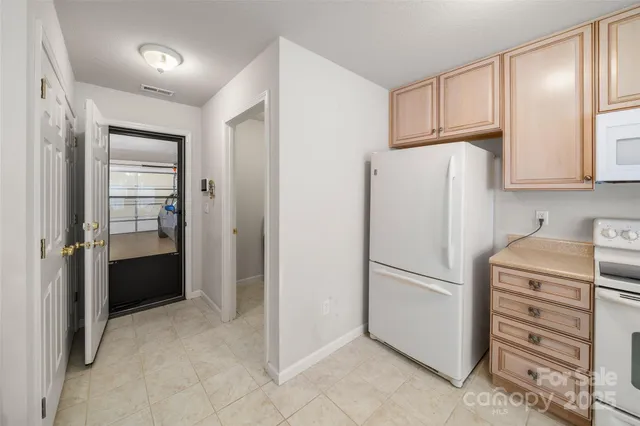 a kitchen with a refrigerator and a stove