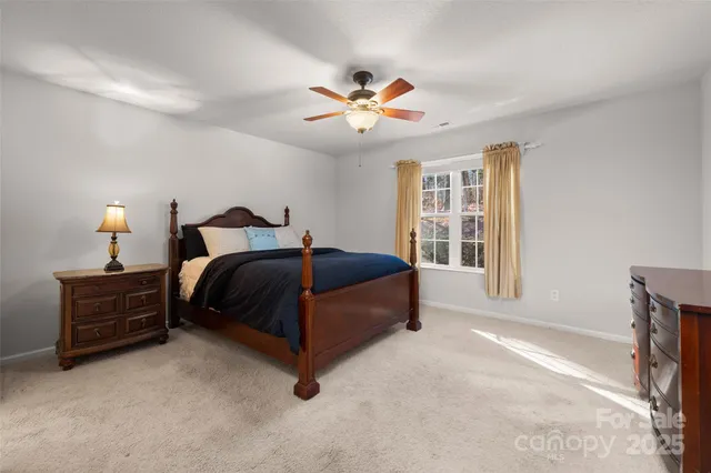 a bedroom with a bed dresser and a window