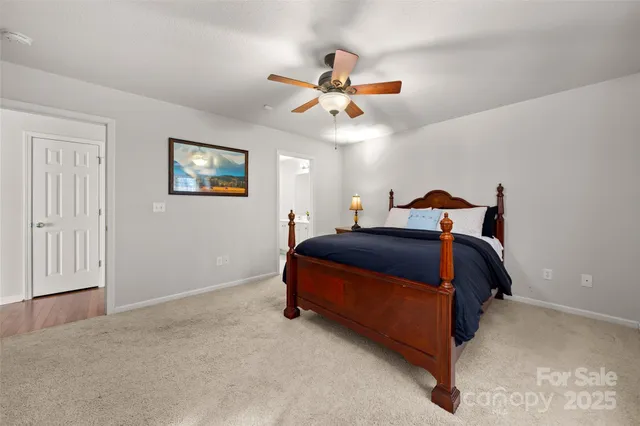 a bedroom with a bed and ceiling fan