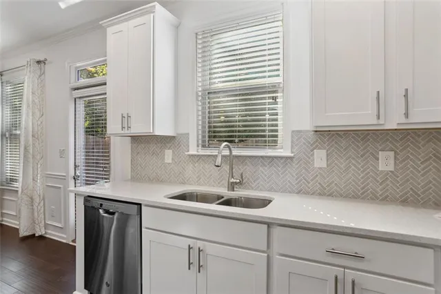 a bedroom with a bed a dresser and flat screen tv